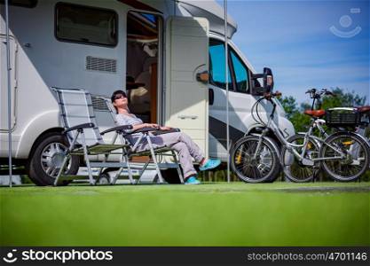Woman resting on a chair on the nature. Caravan car Vacation. Family vacation travel, holiday trip in motorhome