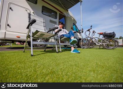 Woman resting on a chair on the nature. Caravan car Vacation. Family vacation travel, holiday trip in motorhome
