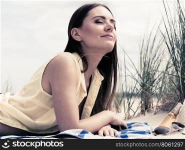 Woman resting on beach.. Relax and leisure. Young woman resting on summer beach. Pretty girl sunbathing on fresh air in summer.