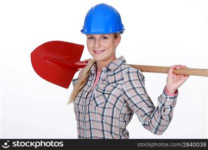 Woman resting shovel across shoulder