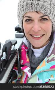 Woman resting skis on shoulder