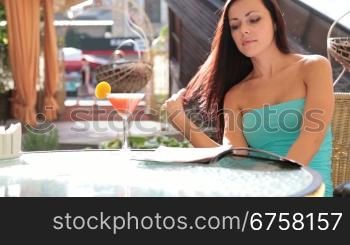 woman rests in Cafe reading the magazine
