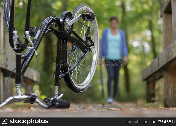 woman returning to her upended bicycle