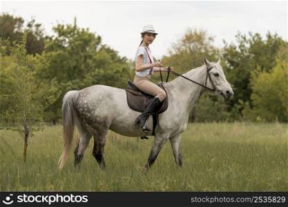 woman ridding horse countryside
