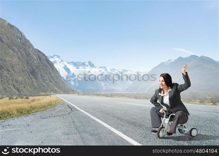 Woman riding bicycle. Young pretty businesswoman riding three wheeled bike