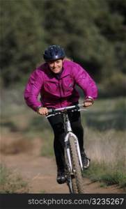 Woman Riding Bike on Trail