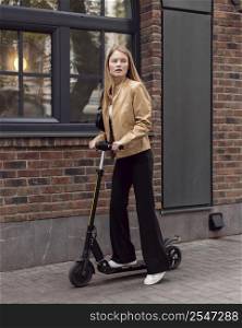 woman riding electric scooter outdoors