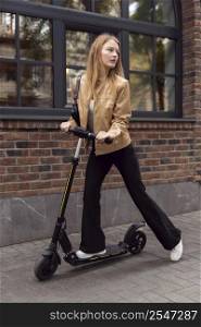 woman riding electric scooter outdoors city