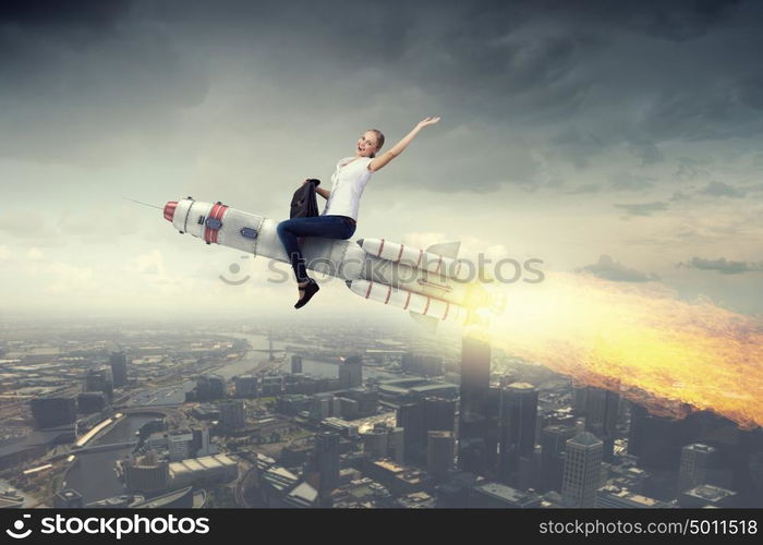 Woman riding missile. Young businesswoman flying in sky on space rocket