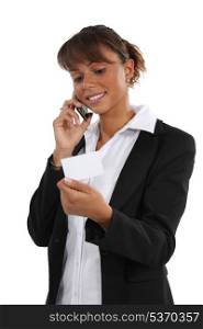 Woman ringing number on business card