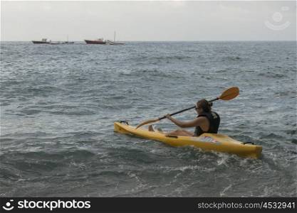 Woman rowing kayak in sea, Positano, Amalfi Coast, Salerno, Campania, Italy