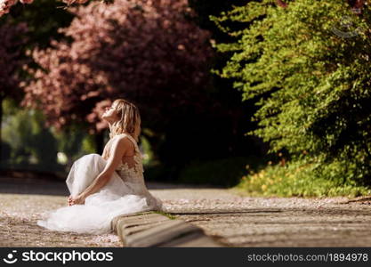 woman&rsquo;s day. beautiful young woman in luxury long dress near blossoming of sakura. stylish girl near blossoming sakura flowers on background in the spring park. Harmony with nature concept.. woman&rsquo;s day. beautiful young woman in luxury long dress near blossoming of sakura. stylish girl near blossoming sakura flowers on background in the spring park. Harmony with nature concept