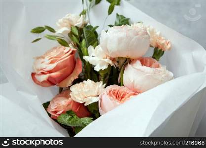 Woman&rsquo;s Day concept. Closeup of bouquet of roses for giving as gift or present. Bouquet of roses represented in glass vase over white background.. Roses on white background