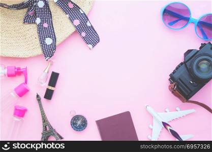 Woman&rsquo;s essentials, air plane model, passport and camera on pink. Woman&rsquo;s essentials, air plane model, passport and camera on pink pastel color background, Travel vacation concept
