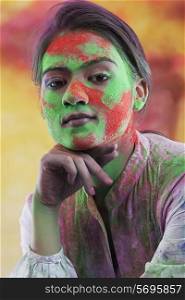 Woman&rsquo;s face covered in holi colours