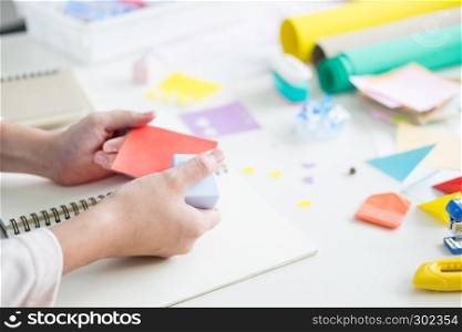 Woman's hand cut paper Making a scrap booking or other festive decorations DIY accessories arrangement