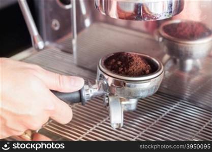 Woman&rsquo;s hand holding coffee grind in group with vintage style, stock photo