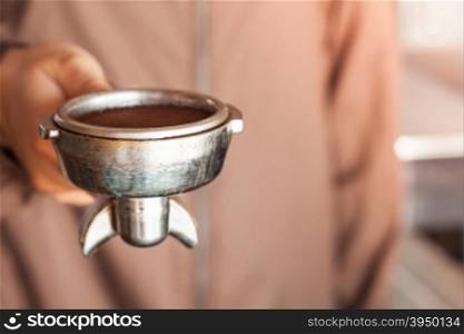 Woman&rsquo;s hand holding coffee grind in group with vintage style, stock photo