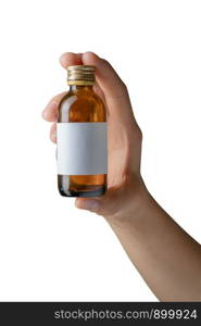 Woman's hand holding empty small brown medicine bottle liquids transparent on white background. File contains a clipping path.