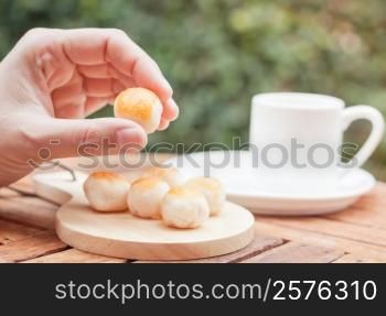 Woman&rsquo;s hand holding mini Chinese cakes, stock photo