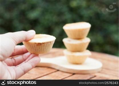 Woman&rsquo;s hand holding mini pies, stock photo