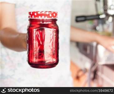 Woman&rsquo;s hand holding red glass, stock photo