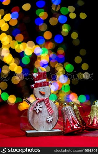 Woman&rsquo;s hands hold christmas decoration. Christmas and New Year holidays background, winter season with Christmas ornaments and blurred lights