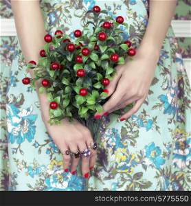 Woman&rsquo;s hands holding a bouquet of berry. Fashion art photo. Beauty and Manicure