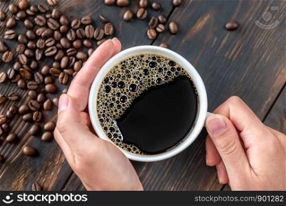 Woman's hands holding a cup of coffee