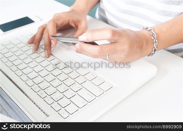 Woman&rsquo;s hands using laptop and credit card. Online payment, internet banking