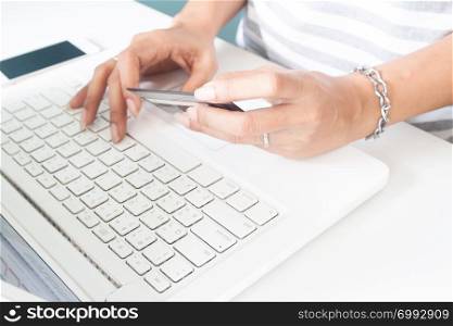 Woman&rsquo;s hands using laptop and credit card. Online payment, internet banking