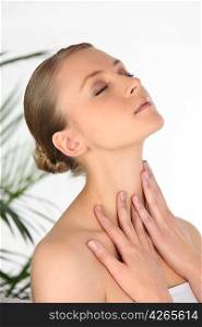 Woman rubbing her own neck