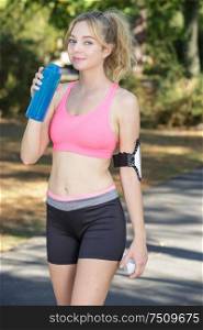 woman runner having a glass of water