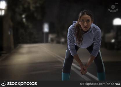 Woman runners on road at night