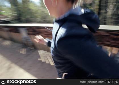 Woman Running Across Wooden Bridge