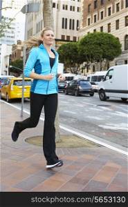 Woman Running Along Urban Street