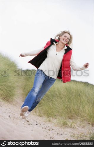 Woman running at beach smiling