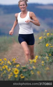 Woman Running in Field With Yellow Flowers