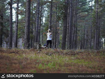 Woman running in forest