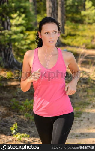 Woman running in the countryside training with headphones