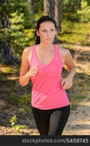Woman running in the countryside training with headphones