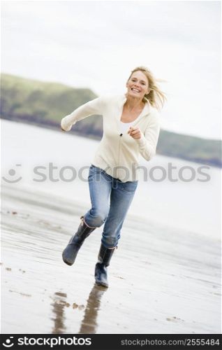 Woman running on beach smiling