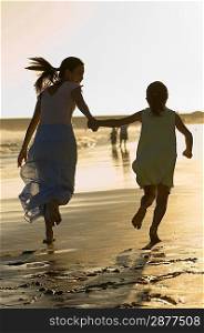 Woman Running on Beach With Daughter