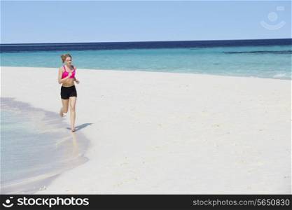 Woman Running On Beautiful Beach
