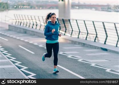 Woman running on riverside