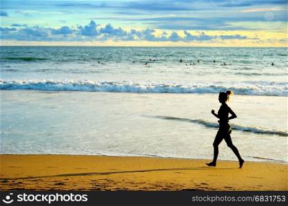 Woman running on the beach at sunset. Bali island, Indonesia