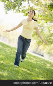 Woman running outdoors smiling