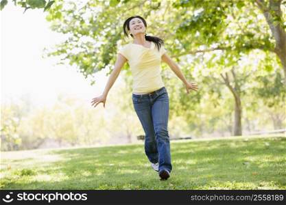 Woman running outdoors smiling