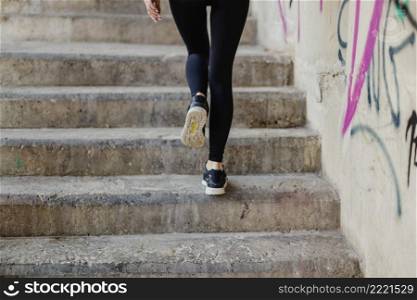 woman running up stairs outside