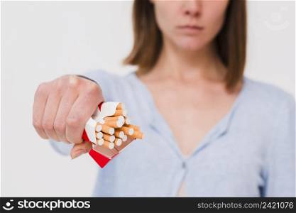 woman s hand holding packet cigarettes